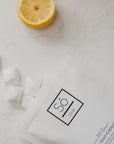 Dish capsules with a lemon on a marble surface, featuring the 'Sö Clean' brand.