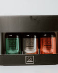 Three holiday essential oil blends in a box with 'Sö' branding on a light gray background