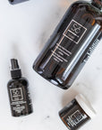 Three bottles of Só Silver on a white marble background representing the Só Silver Bundle containing oral silver, topical silver gel and topical silver spray
